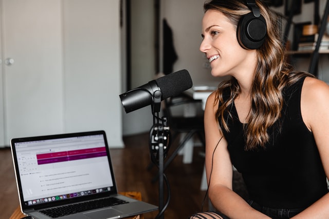 woman recording a podcast at home