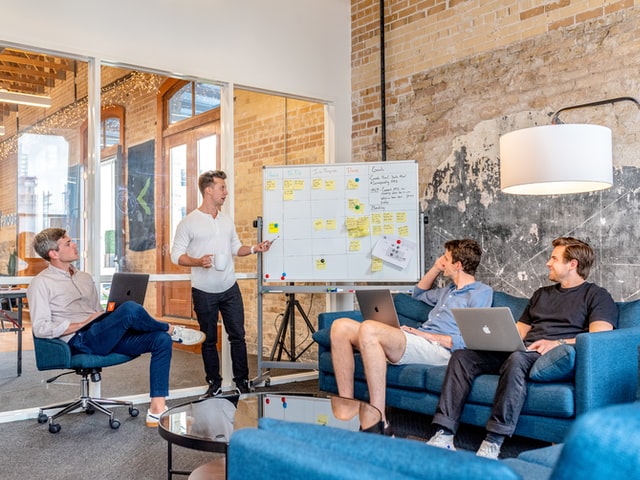 4 men working in a coworking space holding a meeting