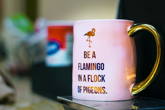 be a flamingo in a flock of pigeons design on pink mug with gold handle