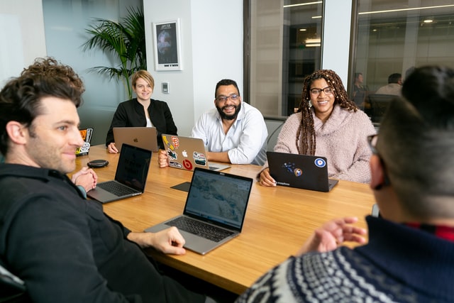 a diverse group of people brainstorming during a meeting in a conference room