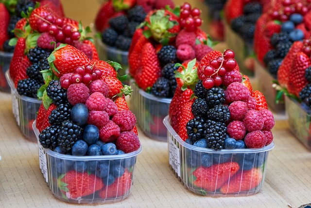 different berries in plastic containers