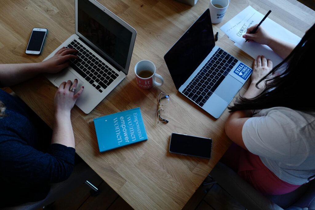 2 women working on their laptops in a coworking office space