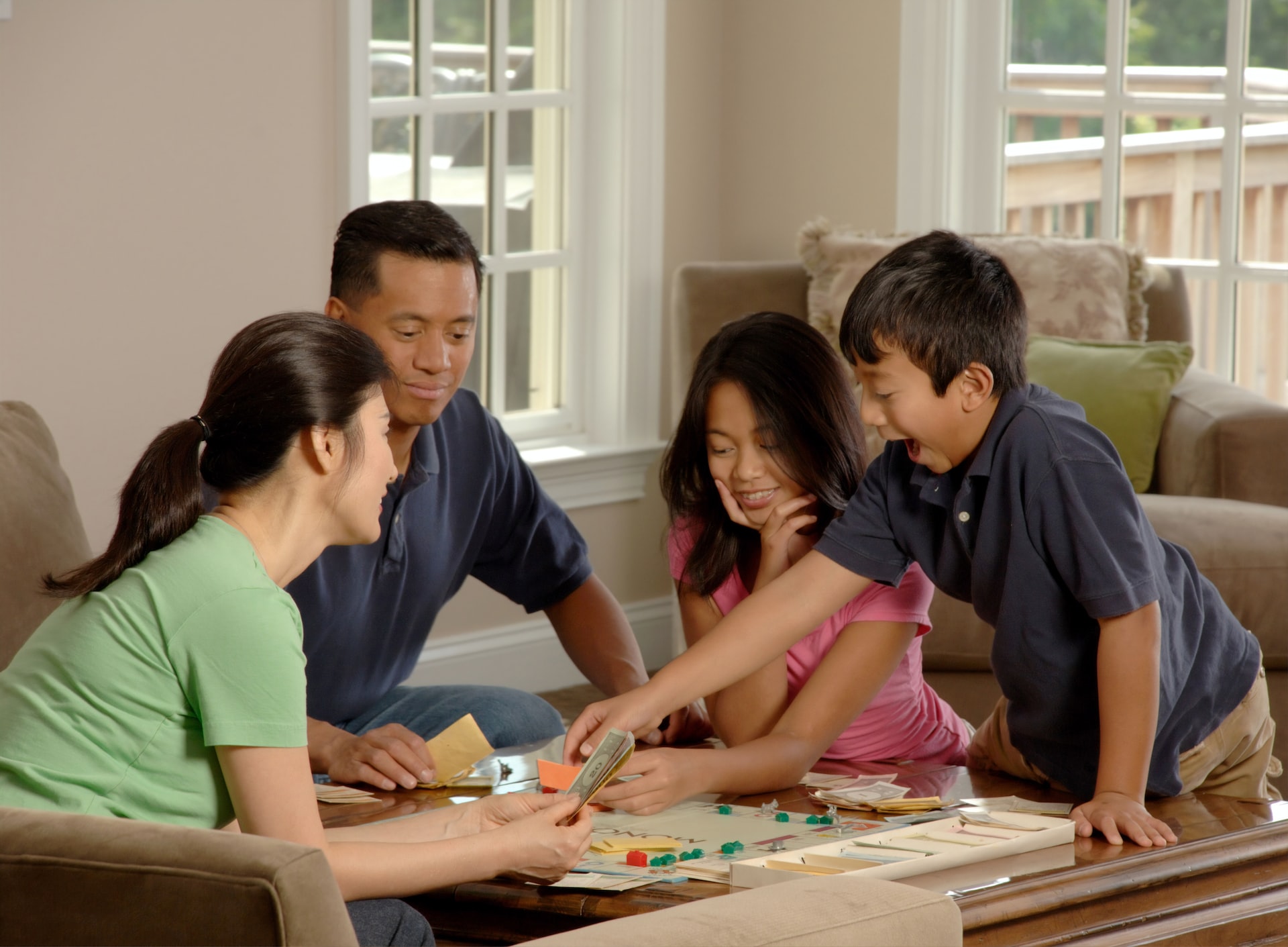 A family with two young kids playing a board game