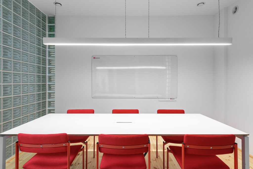 A meeting room with red chairs